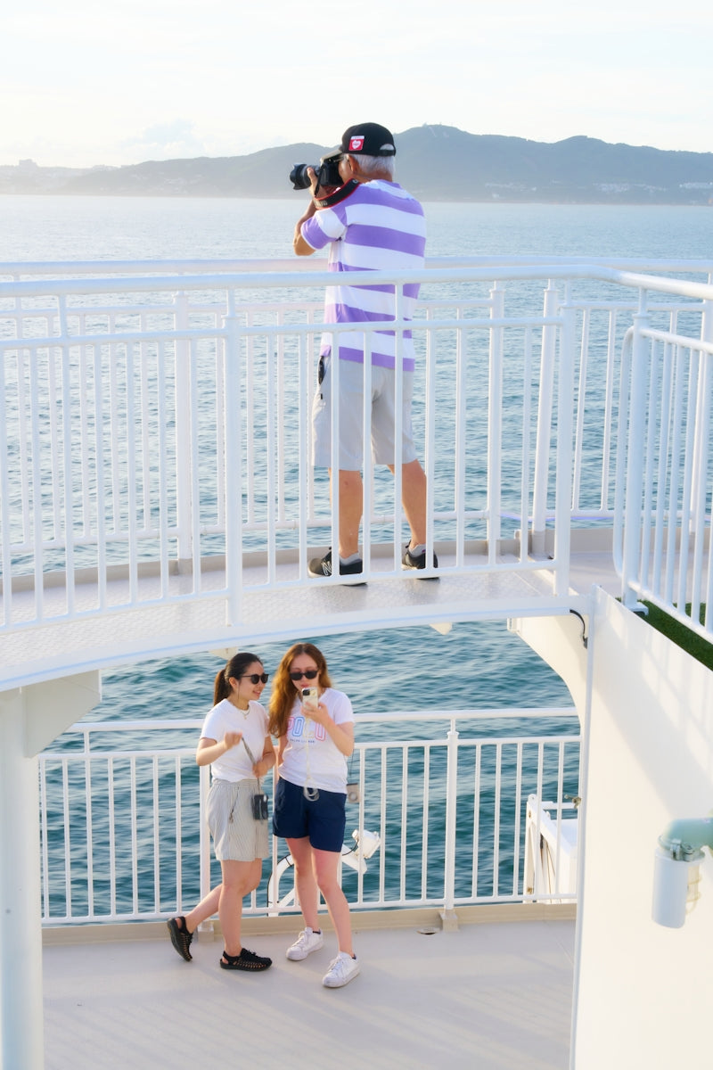 A couple of people that are standing on a boat