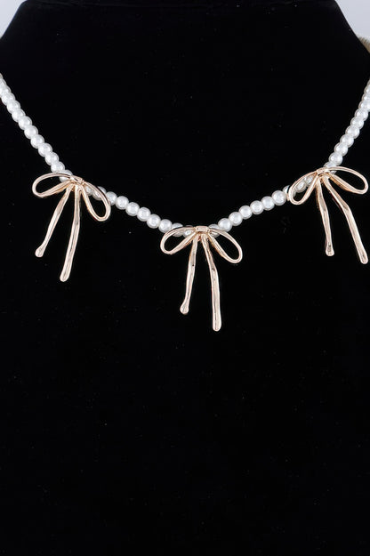 Pearl And Metal Ribbon Charm Necklace