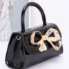 Faux Leather Top Handle Bag with Metal Ribbon Accent