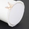 Faux Pearl Bracelet with Rhinestone Bow Accent
