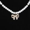 White Pearl Bow Necklace – 16″ Collarbone Chain